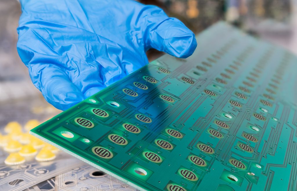 closeup of the conformal coating process on a printed circuit board